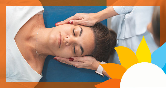 a woman having the sides of her face massaged